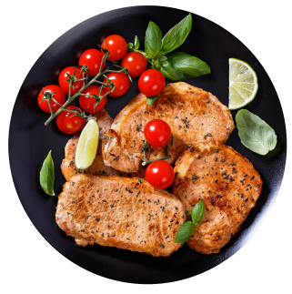 Cooked pork loin cutlets prepared with tomatoes on a plate